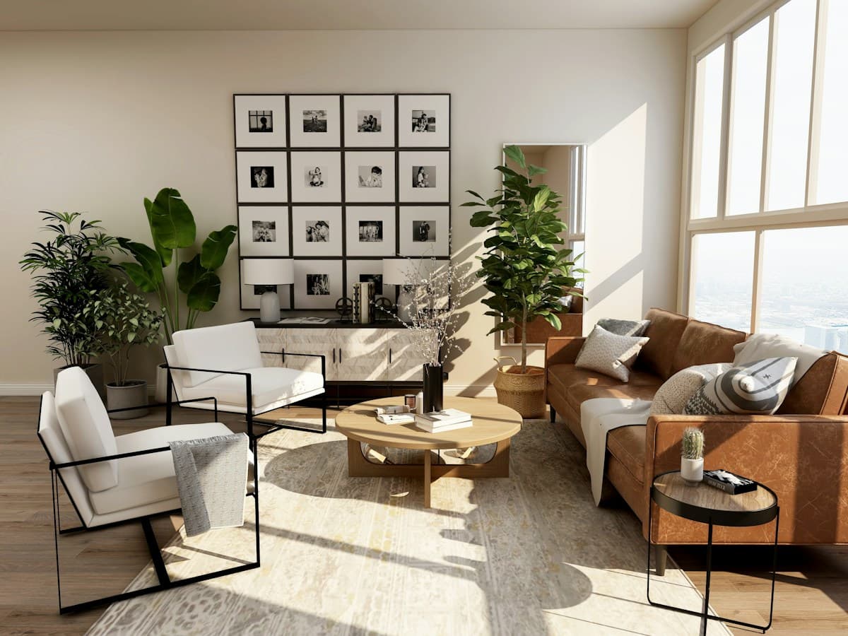 A sunlit living room with sofas, houseplants and large windows.